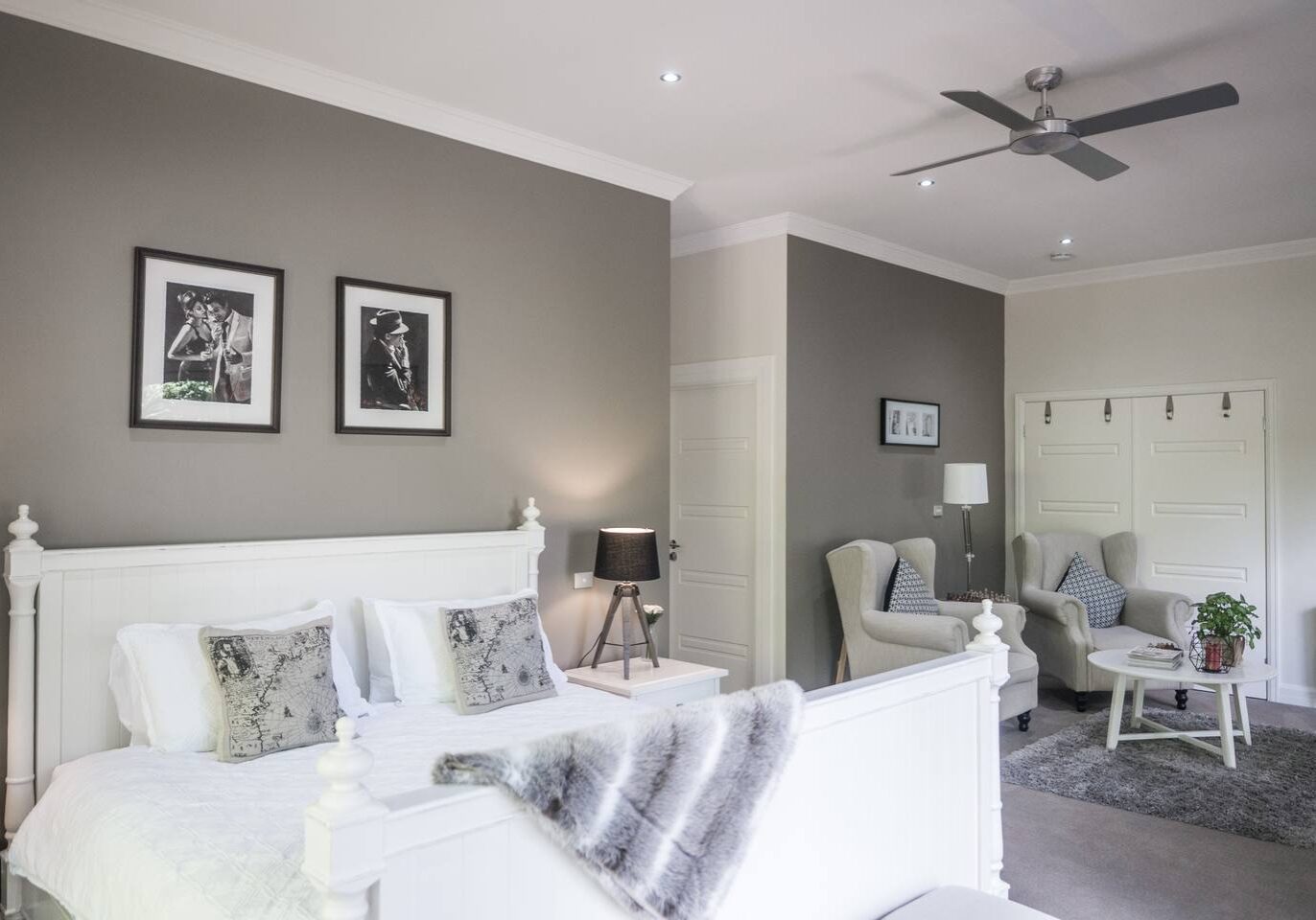 B&B with bed and sofa in light grey and white tones.